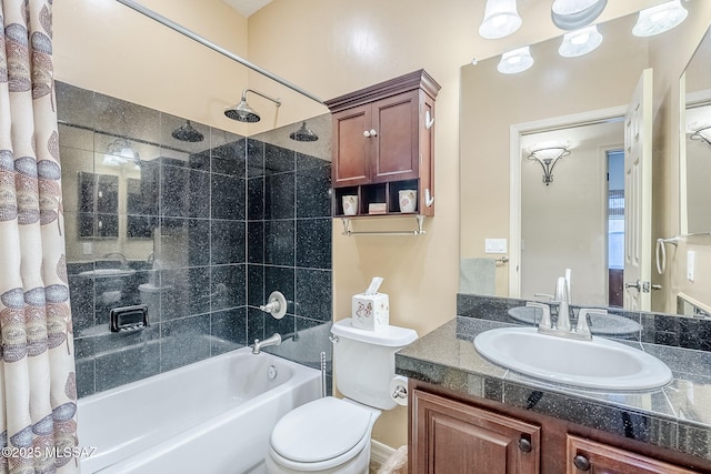 full bathroom featuring shower / bath combination with curtain, vanity, and toilet