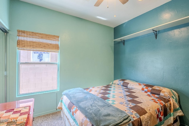 bedroom featuring ceiling fan and carpet