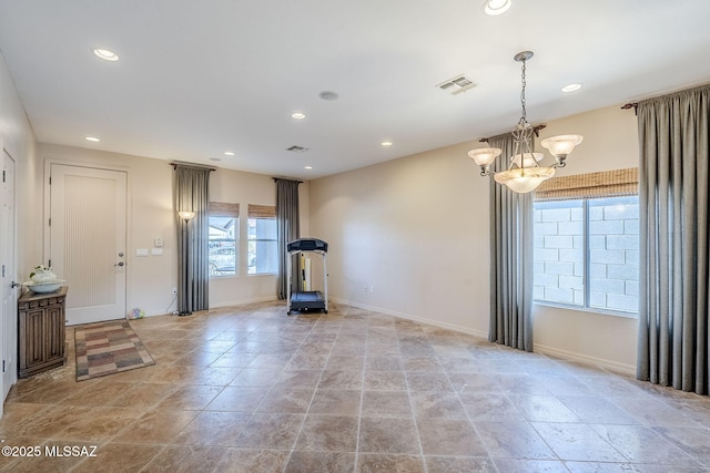 workout area with a chandelier