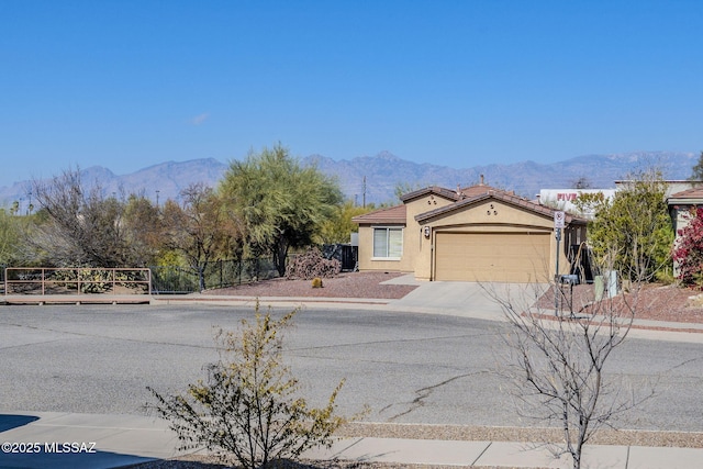 view of front of house featuring a mountain view and a garage