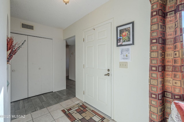 entrance foyer with a textured ceiling