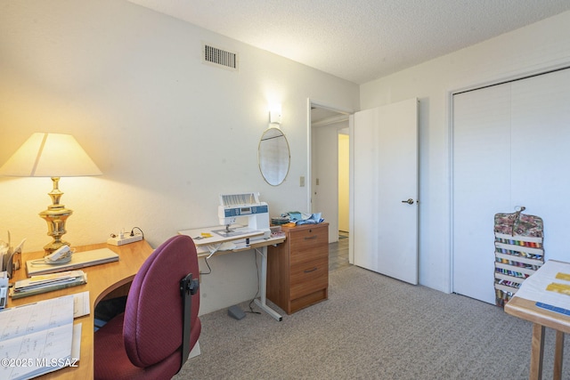 carpeted office featuring a textured ceiling