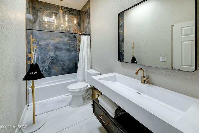 full bath with toilet, vanity, shower / bath combo with shower curtain, and a textured wall