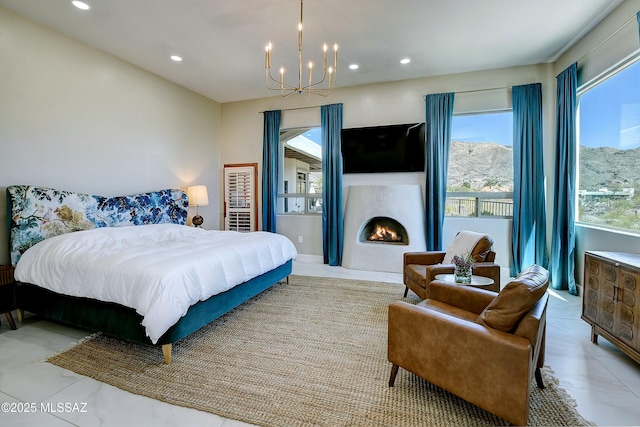 bedroom with recessed lighting, a lit fireplace, and an inviting chandelier