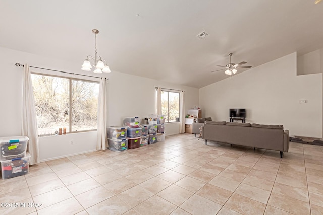 tiled living room with lofted ceiling and ceiling fan with notable chandelier