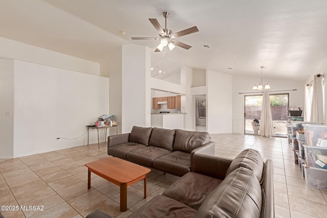 living room featuring light tile patterned floors, ceiling fan with notable chandelier, and high vaulted ceiling