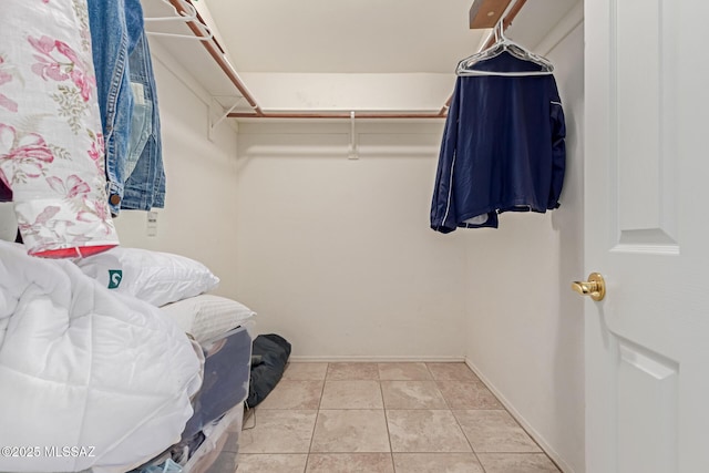 spacious closet with light tile patterned floors