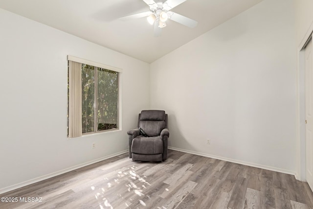 unfurnished room with ceiling fan, vaulted ceiling, and light hardwood / wood-style flooring