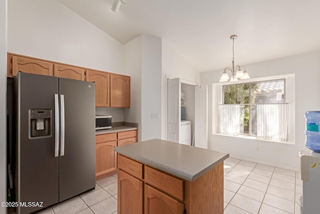 kitchen with pendant lighting, light tile patterned floors, appliances with stainless steel finishes, an inviting chandelier, and a center island