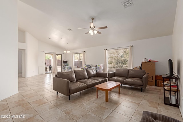 tiled living room with high vaulted ceiling and ceiling fan with notable chandelier