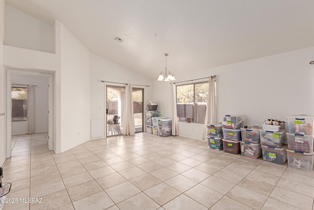 interior space featuring a notable chandelier, light tile patterned floors, and high vaulted ceiling