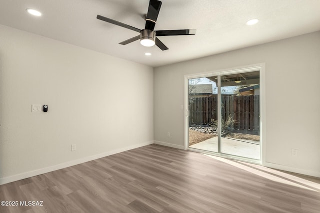 unfurnished room with wood-type flooring and ceiling fan