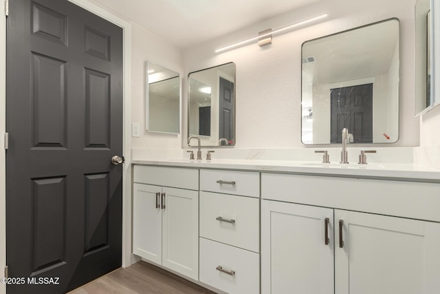 bathroom featuring vanity and hardwood / wood-style floors