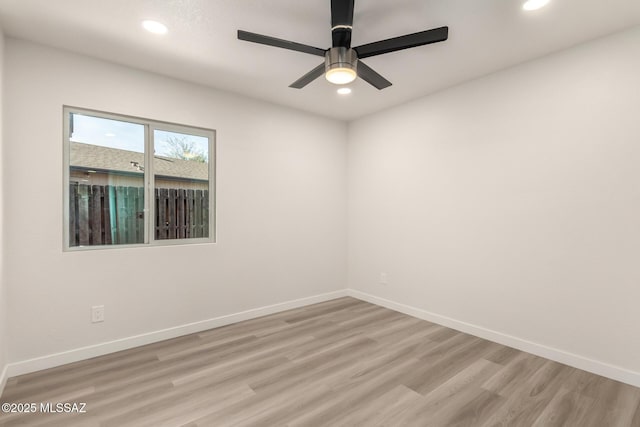 spare room featuring ceiling fan and light hardwood / wood-style flooring