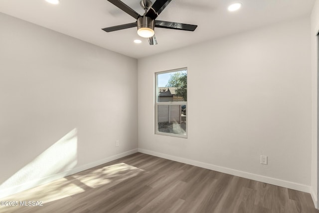 spare room featuring hardwood / wood-style flooring and ceiling fan