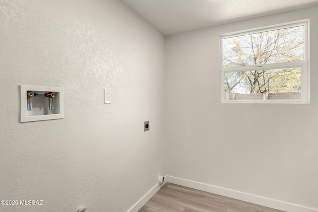 washroom with hookup for an electric dryer and hardwood / wood-style floors