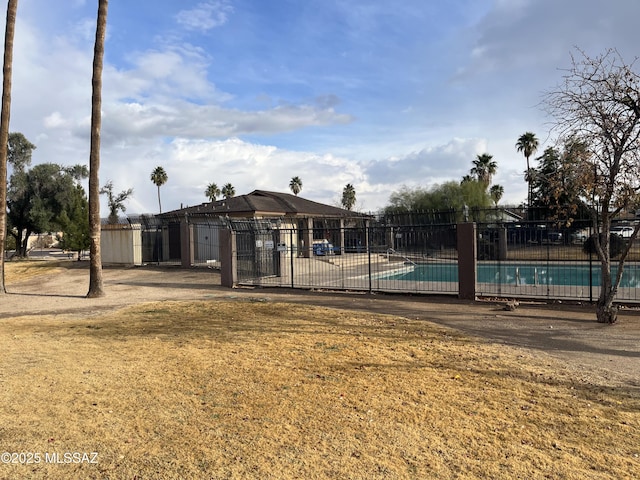 view of swimming pool featuring a lawn