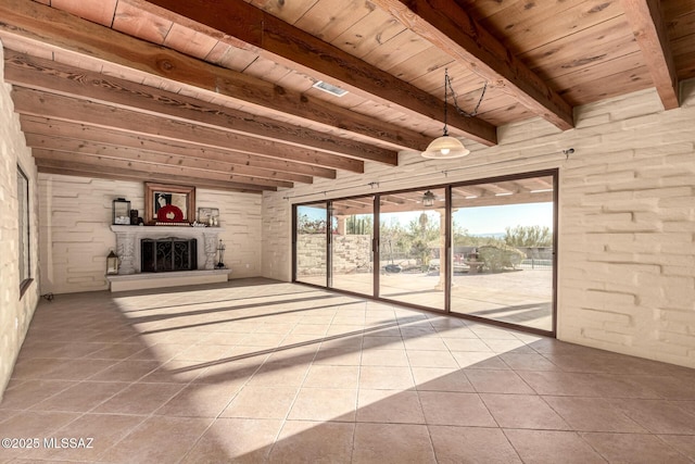 unfurnished living room with beamed ceiling, tile patterned flooring, and wood ceiling