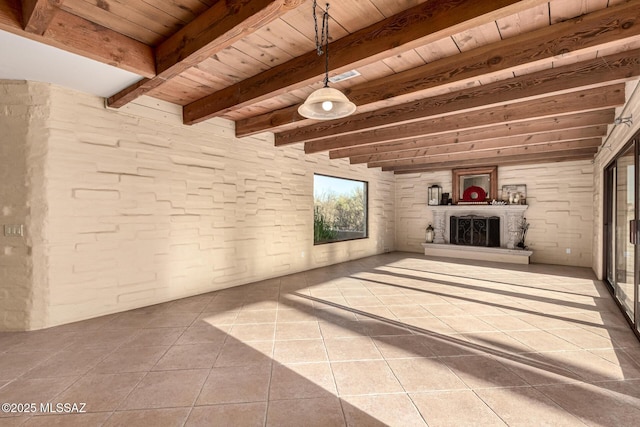 unfurnished living room with tile patterned flooring, beam ceiling, and wooden ceiling