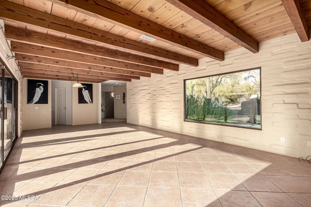 interior space featuring beamed ceiling, light tile patterned flooring, and wooden ceiling