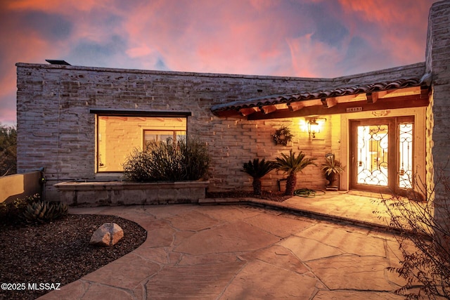 view of patio terrace at dusk