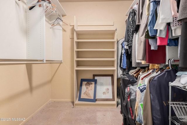 spacious closet with light tile patterned floors