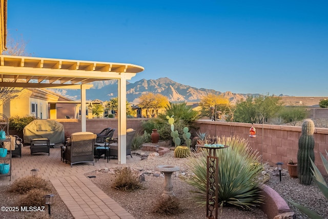 view of patio featuring area for grilling, a pergola, and a mountain view