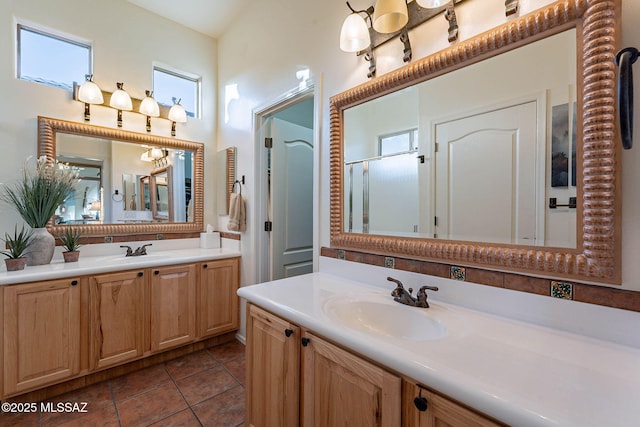 bathroom with tile patterned flooring, vanity, and an enclosed shower