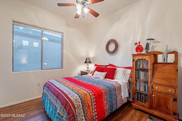 bedroom with dark hardwood / wood-style floors and ceiling fan