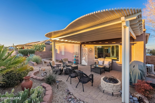 view of patio with an outdoor living space with a fire pit and grilling area