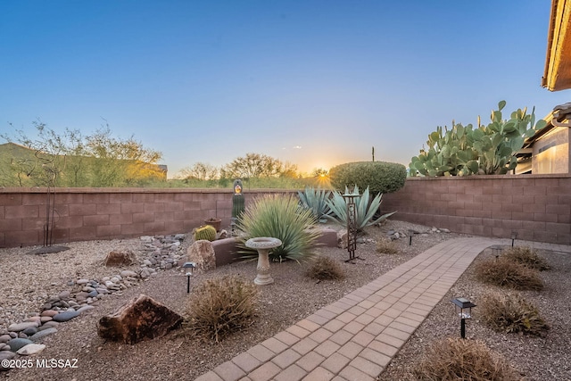 view of yard at dusk