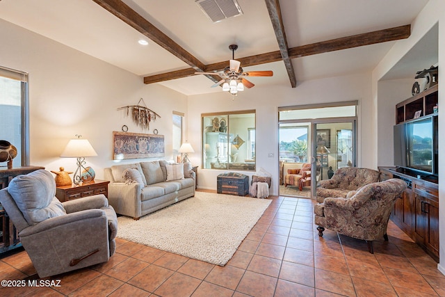 tiled living room featuring ceiling fan and beam ceiling