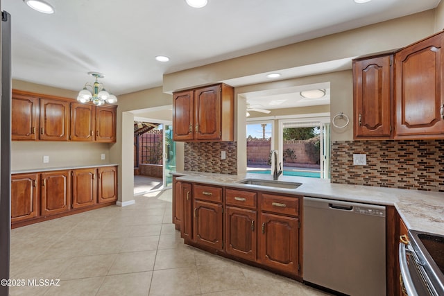 kitchen featuring light tile patterned flooring, sink, appliances with stainless steel finishes, ceiling fan, and decorative backsplash