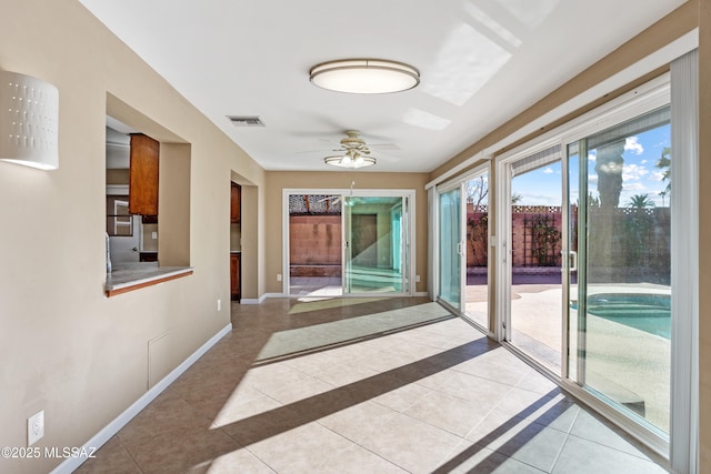 hall featuring light tile patterned floors