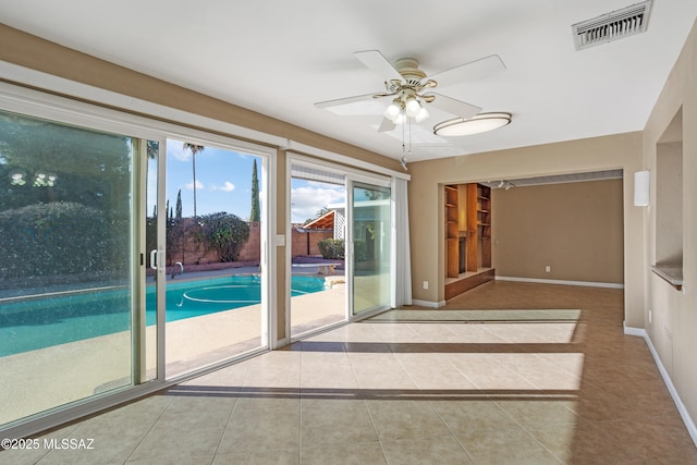 interior space featuring light tile patterned floors and ceiling fan