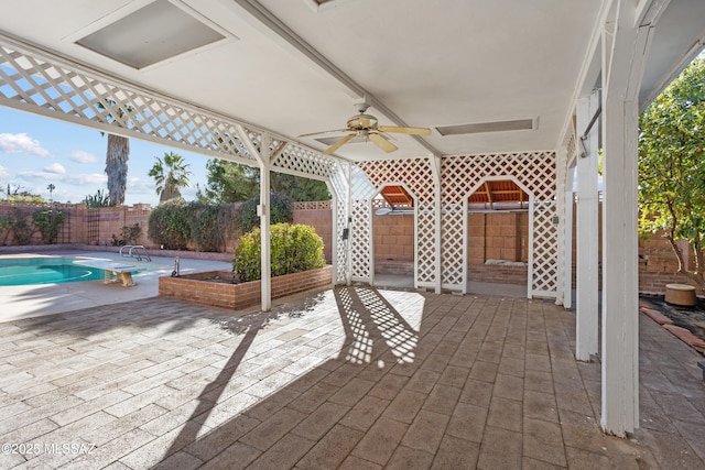 view of patio with a fenced in pool and ceiling fan