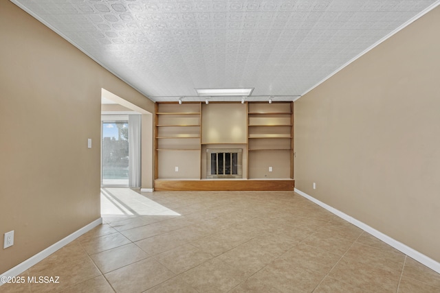 unfurnished living room with track lighting and light tile patterned floors