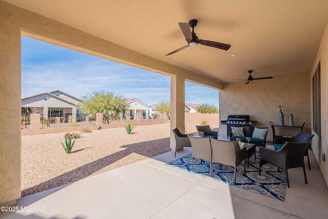 view of patio featuring a grill, outdoor lounge area, and ceiling fan