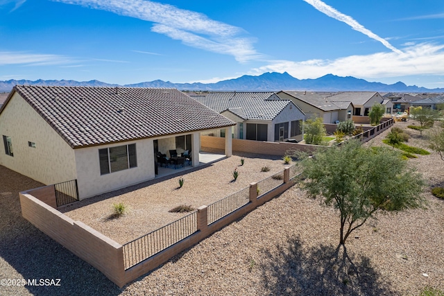 exterior space featuring a mountain view and a patio area