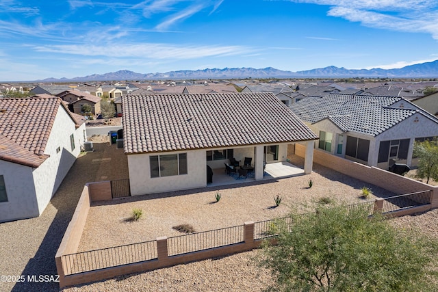 back of house featuring a mountain view and a patio