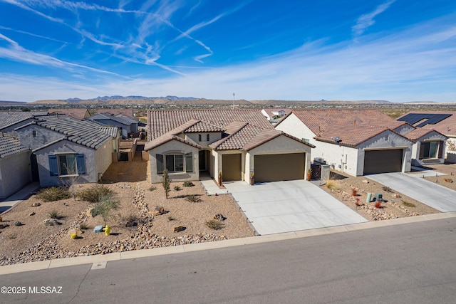 view of front of house featuring a mountain view and a garage