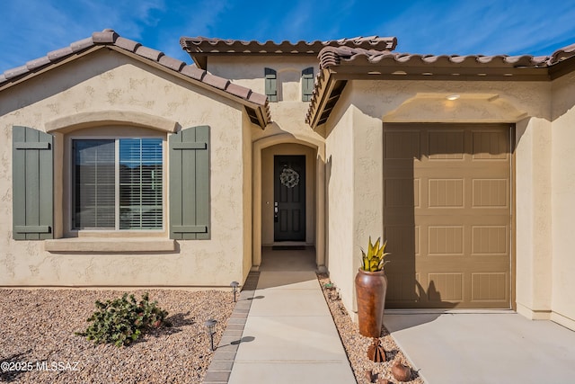 view of exterior entry featuring a garage