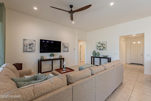 tiled living room with ceiling fan