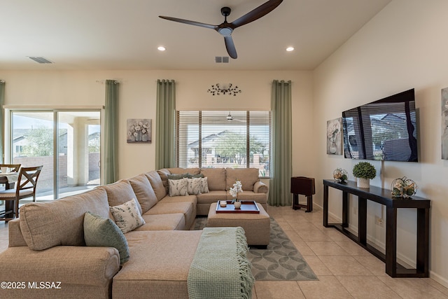 tiled living room with plenty of natural light and ceiling fan