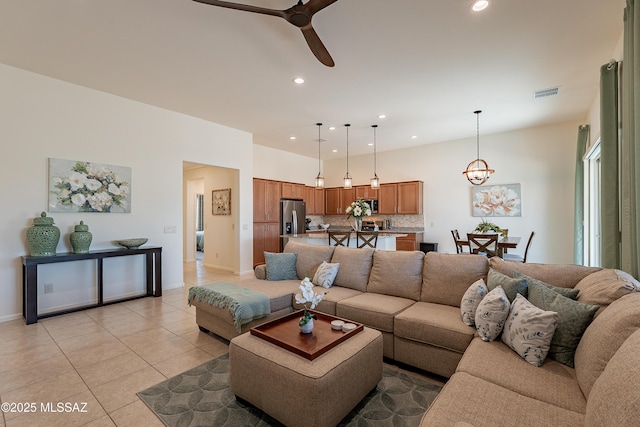 tiled living room featuring ceiling fan