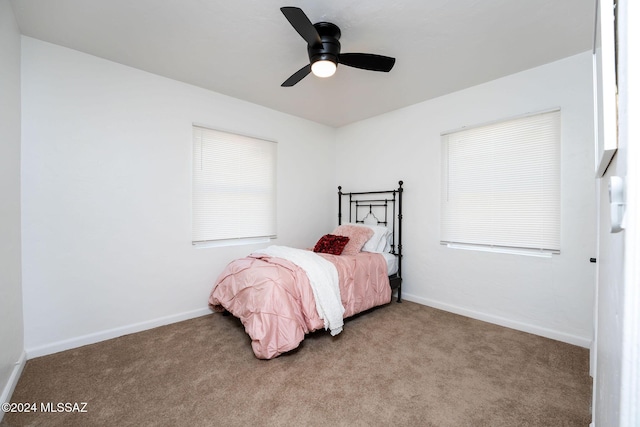 bedroom with light carpet, ceiling fan, and baseboards