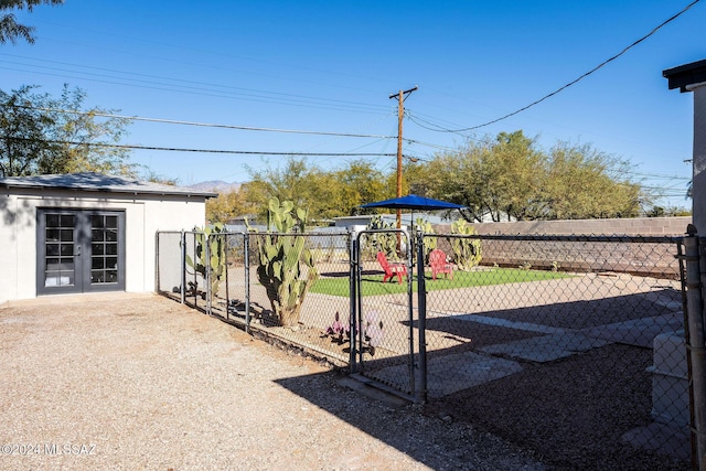 view of yard with french doors, a playground, and fence