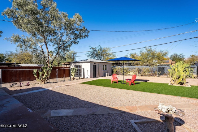 view of yard featuring an outdoor structure and fence