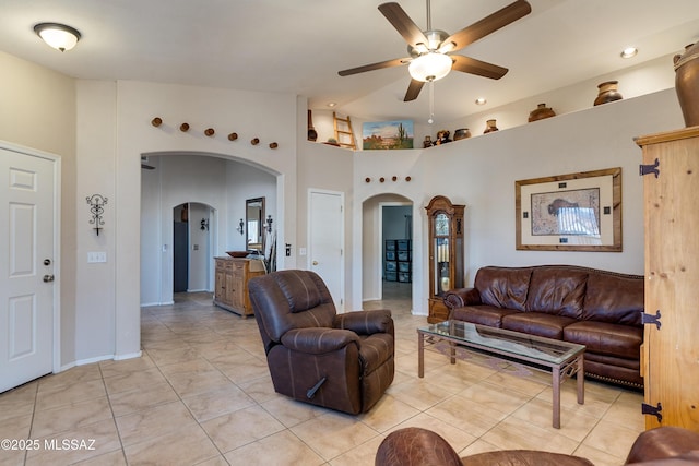 tiled living room with ceiling fan