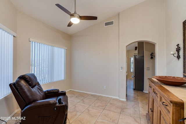 living area with sink, a wealth of natural light, ceiling fan, and light tile patterned floors